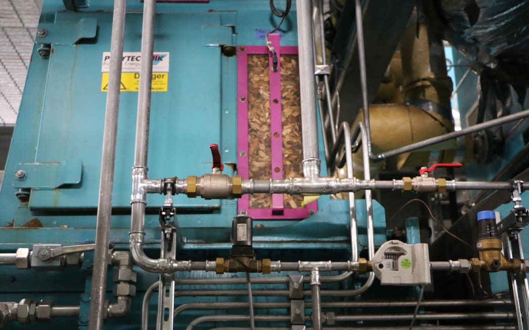 The wood chips being sent into a boiler.