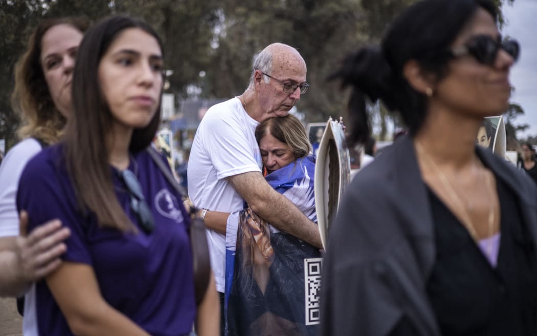 Two people embrace as relatives and supporters of Israelis killed in the October 7 Hamas attack attend a ceremony at the Nova memorial near Kibbutz Reim in southern Israel on the first anniversary of the attacks, October 7, 2024. - Thousands of people gathered over the weekend for the first emotional commemorations marking the anniversary of Palestinian militant group Hamas's October 7, 2023 attack on Israel.
The first candlelight vigils, memorials and marches to mark the anniversary were held in cities ranging from Tel Aviv to London, Paris and Berlin, with more set to be held around the world on Monday. (Photo by JOHN WESSELS / AFP)
