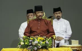 Brunei's Sultan Hassanal Bolkiah (C) attends an event in Bandar Seri Begawan on April 3, 2019.