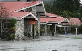 The Waiho River bursts its banks and runs through the Mueller Hotel in Franz Josef