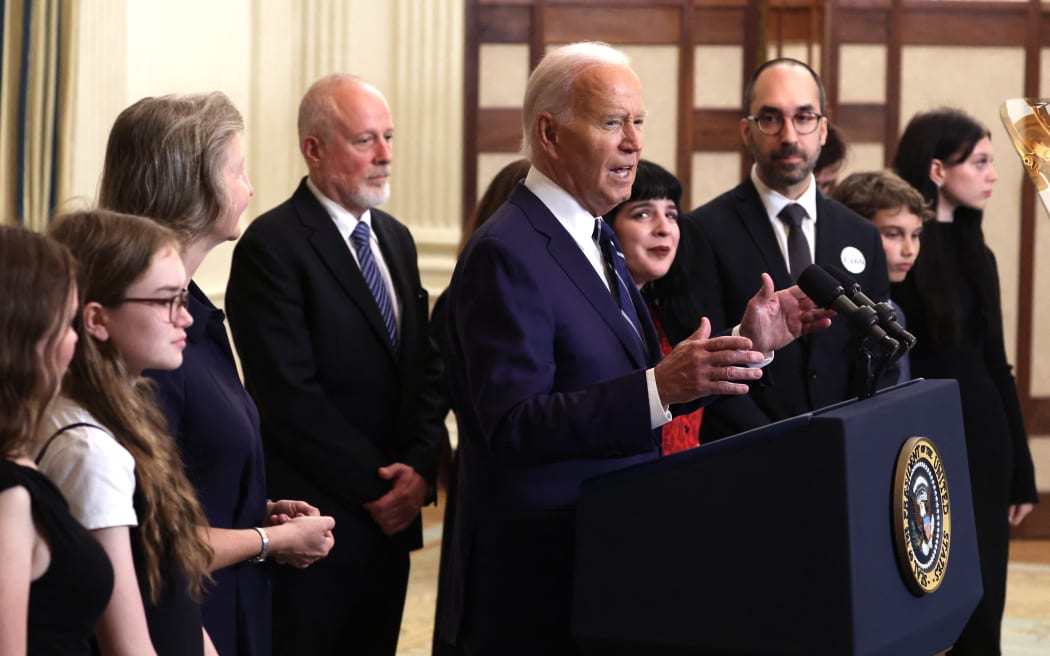 WASHINGTON, DC - AUGUST 01: U.S. President Joe Biden, joined by relatives of prisoners freed by Russia, delivers remarks on the release of Wall Street Journal reporter Evan Gershkovich and former U.S. Marine Paul Whelan from Russian captivity, in the State Dining Room at the White House on August 01, 2024 in Washington, DC. The two, along with Alsu Kurmasheva, a dual U.S.-Russian citizen and Radio Free Europe journalist, Vladimir Kara-Murza, a Washington Post columnist, and others were released in a prisoner exchange with Russia.   Alex Wong/Getty Images/AFP (Photo by ALEX WONG / GETTY IMAGES NORTH AMERICA / Getty Images via AFP)