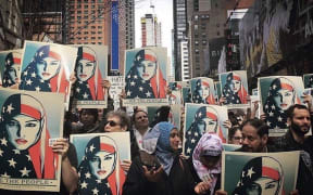 People with We The People posters marching on Inauguration Day in the United States last year.