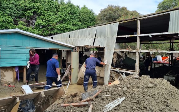 Fijian firefighters and other volunteers help clean out Rawinia Anderson's Esk Valley family home.