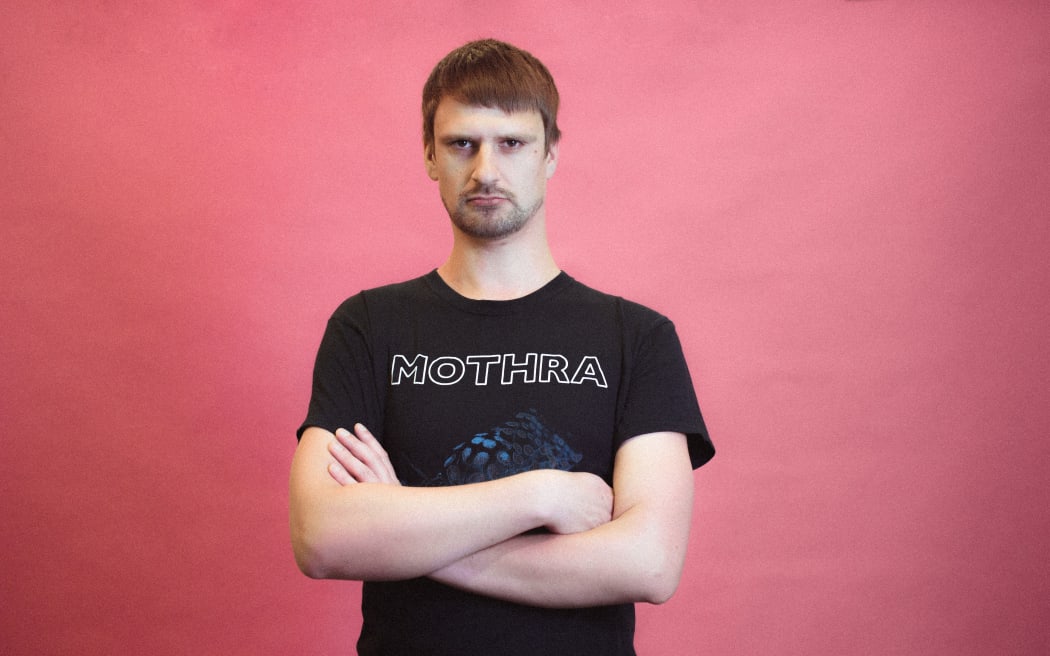 RNZ broadcast engineer and metal fan Alex Baron in his Mothra t-shirt