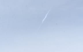 The photo was taken looking directly south in the Hutt Valley. An eyewitness says there was a huge flash of light as the meteor combusted and disintegrated.