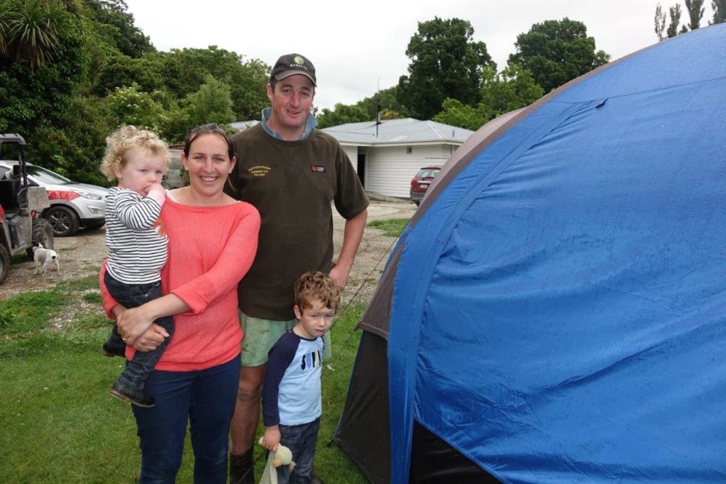 Tom and Angela Loe with Regan, 3 and Kyra, 21 months. Missing from the photo is five-year-old Eloise who was at school. The family has just moved back into their house from the tent they've been living in.