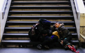 A family waits to board a train at Budapest's Keleti railway station.