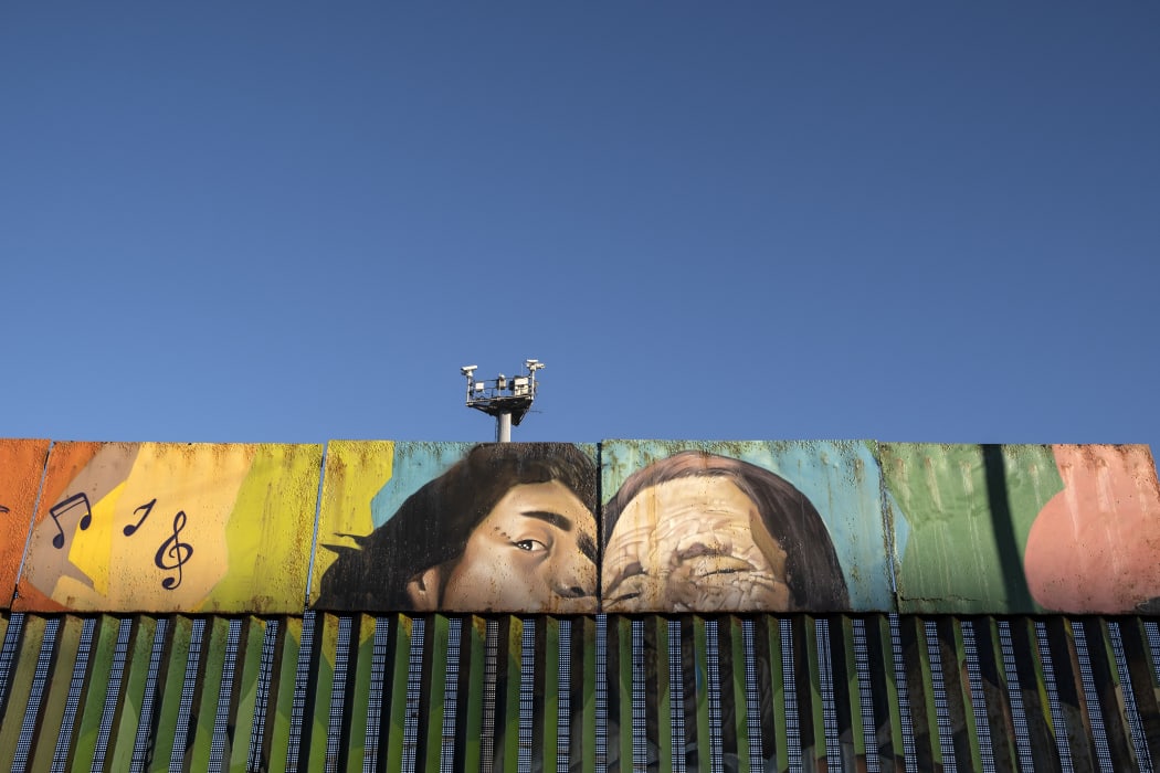 Paintings on the US-Mexico border at the Friendship Park seen from Baja California state in Mexico on January 16, 2021.