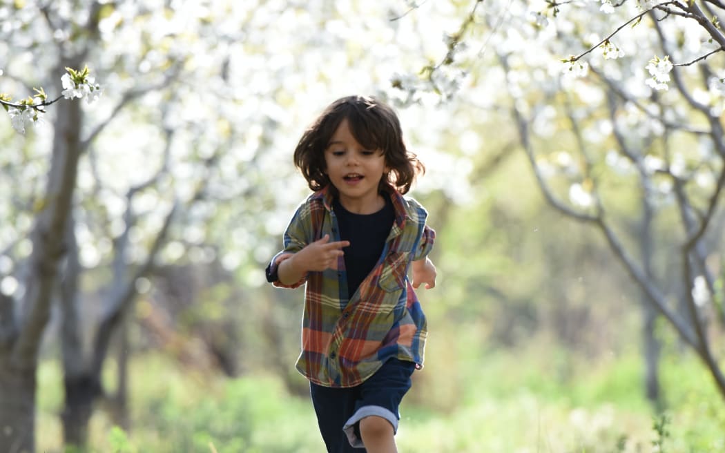 Child running through field