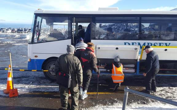 Snow seekers getting on replacement buses.