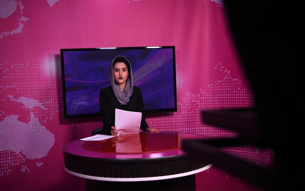 Afghan presenter Diba Akbari, 21, takes part in a live news broadcast for Zan TV (Women's TV) in Kabul on 18 February, 2019.