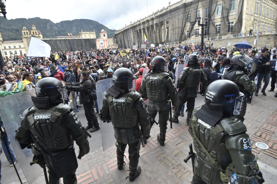 Riot police take position during a march against the government of Colombian President Ivan Duque within a national strike in Bogota on November 27, 2019.