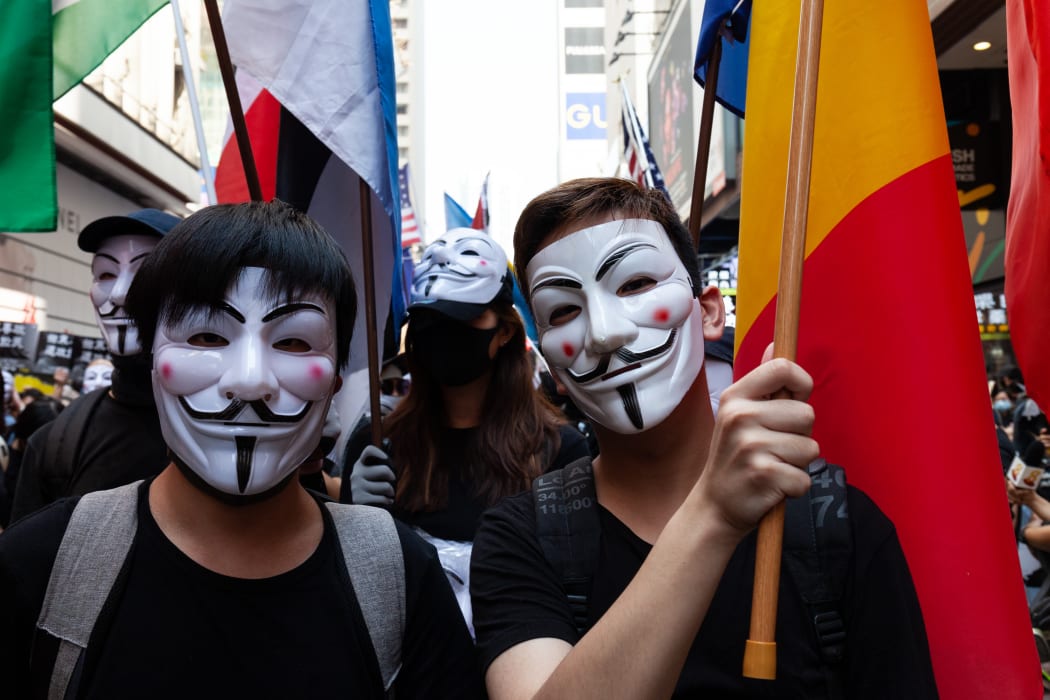 Hong Kong Protester wearing masks and marching with flags representing the countries that mentioned they support to Hong Kong protester, in Hong Kong, China, on October 1, 2019.