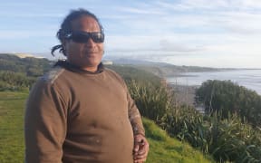Surfer Tama Liunaihetau checks out the conditions at Onuku Taipari / Back Beach in New Plymouth.