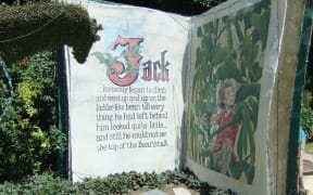 A large storybook display in a garden, telling the story of Jack and the Beanstalk.