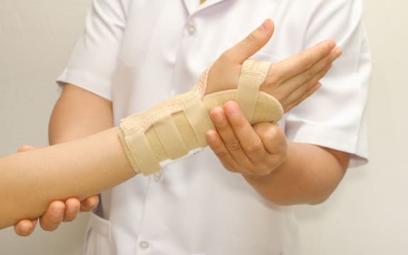 someone with a brace on their hand