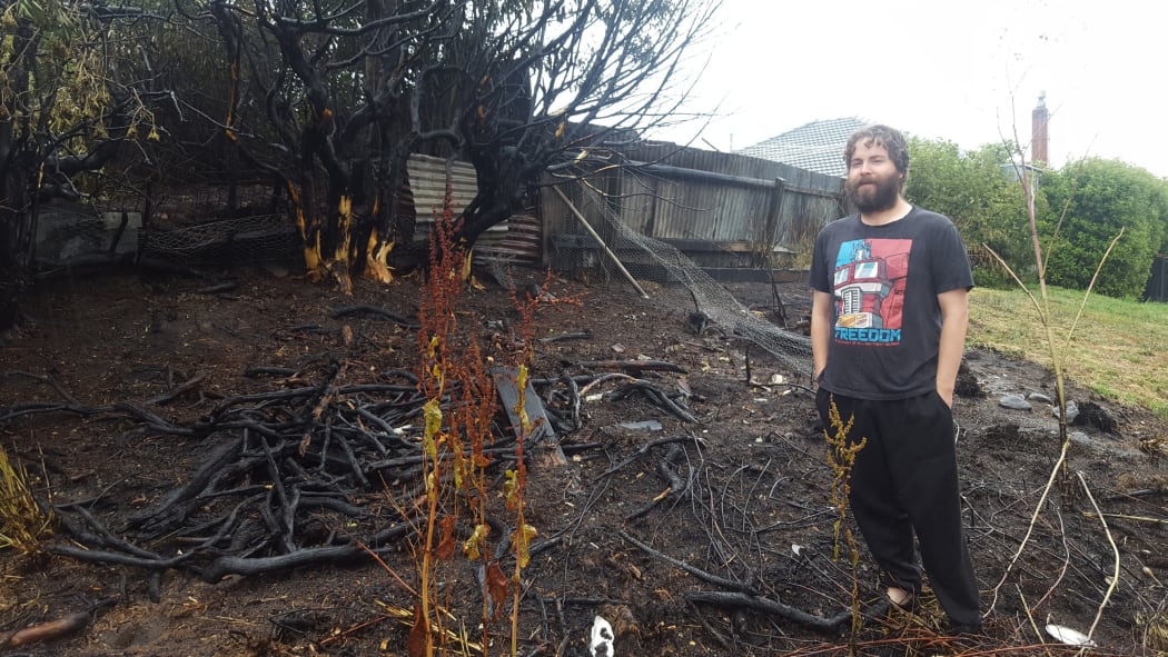 Daniel Davidson in his burned back yard.