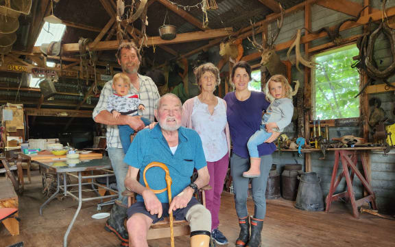 The Pickens family gathered in the woolshed, with Lew seated.