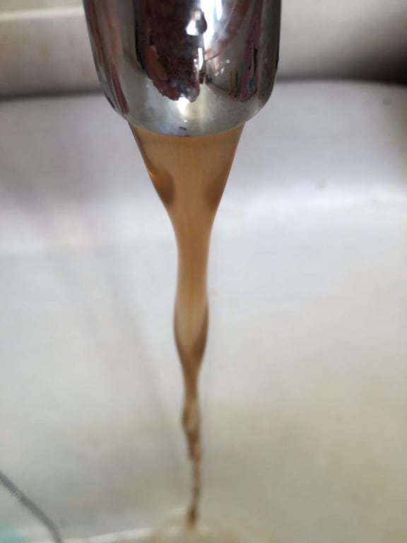Discoloured water flows from a tap in Kaeo.