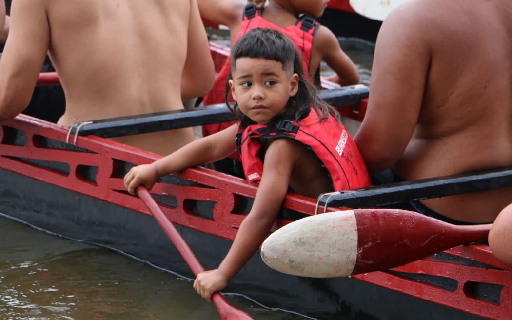 The waka flotilla makes it way to Te Tii beach on Waitangi Day.