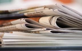 A stack of folded newspapers (file)