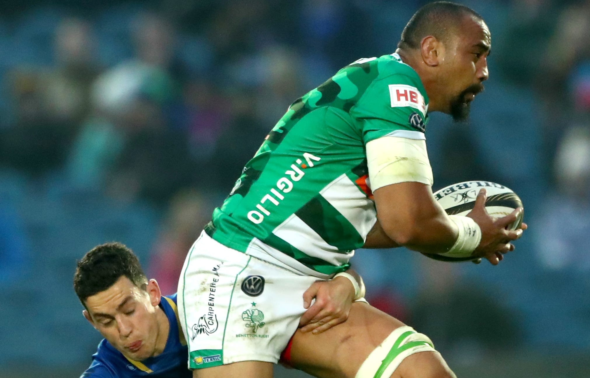 Benetton Treviso's Nasi Manu attempts to evade the tackle of Leinster's Noel Reid.