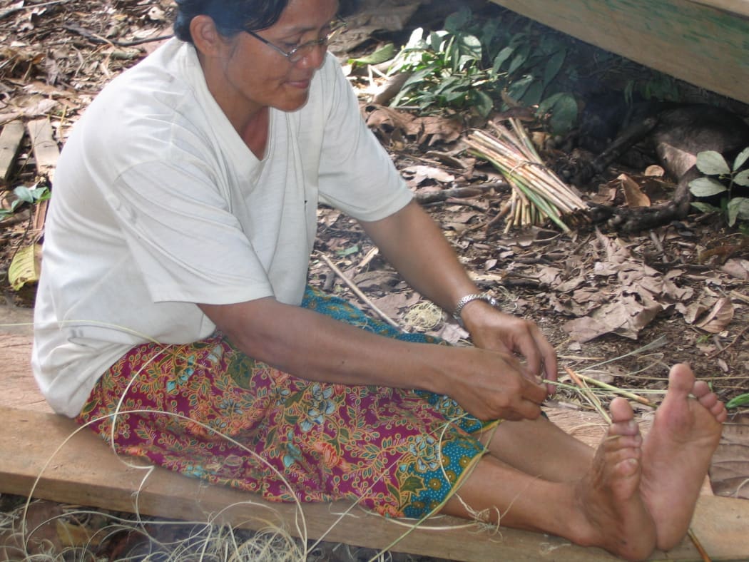 A person from the Penan tribe starting to weave an item.