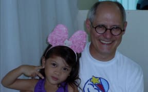 Tristin De Chalain from Operation Hope with a little girl in the Philippines whose face he repaired.