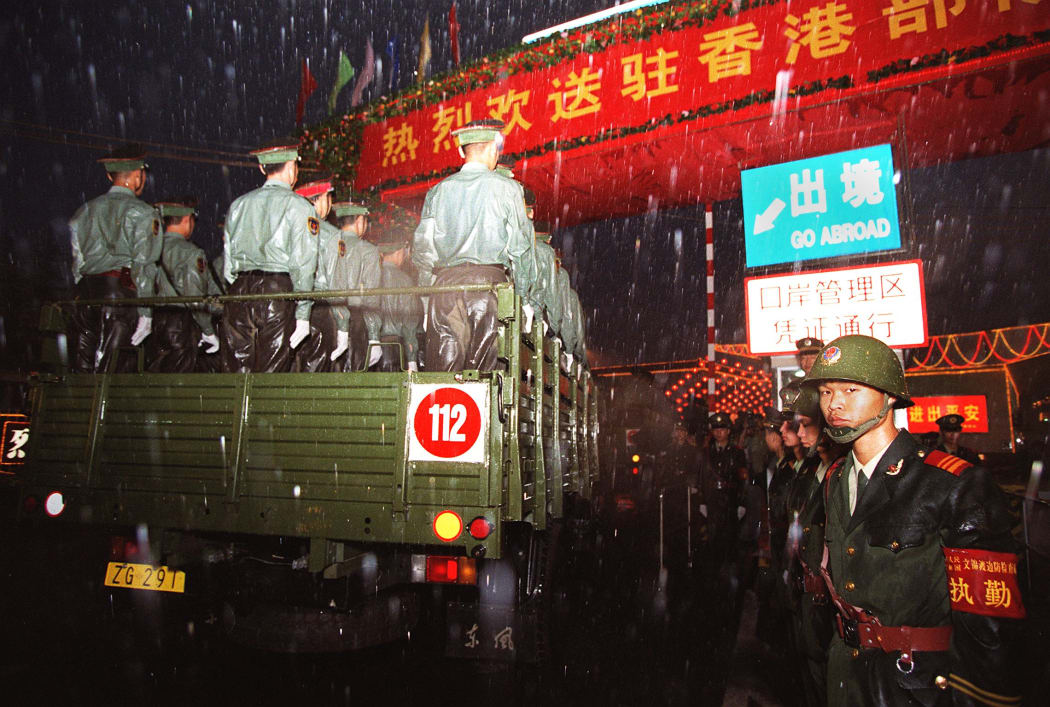 Some 4000 People's Liberation Army troops began pouring into Hong Kong at dawn in the first hours after the territory returned to Chinese rule.