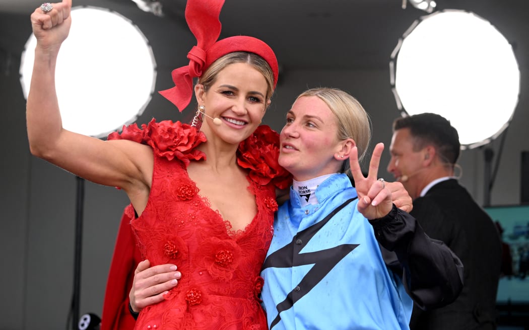 Australian jockey Jamie Melham (R) who rode Half Yours to victory in the Melbourne Cup horse race poses with 2015 race winner Michelle Payne at the Flemington Racecourse in Melbourne on November 4, 2025. Melham became only the second woman jockey to win the Aus$10 million (US$6.5 million) Melbourne Cup on November 4, steering Half Yours to victory in Australia's "race that stops a nation". (Photo by William WEST / AFP) / -- IMAGE RESTRICTED TO EDITORIAL USE - STRICTLY NO COMMERCIAL USE --