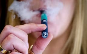 A woman smoking an electronic cigarette