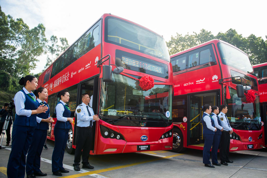 Bus drivers and stewardesses with new BYD electric double-decker buses in Shenzhen city. The 16,000 buses in the southern city was 100 percent electric by the end of 2017. BYD became the world's biggest manufacturer of electric vehicles in 2016, exporting to 50 countries.