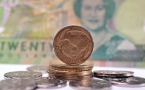 020514. Photo Diego Opatowski / RNZ. New Zealand money. Currency. Twenty dollars note. 2 dolars coin, 1 dollar coin.