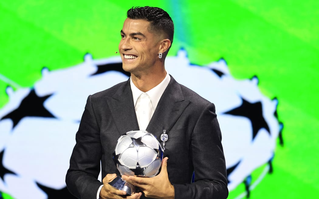 Portugal's national team player and Saudi Al-Nassr's forward Cristiano Ronaldo holds his All-Time Goalscorer Award in the UEFA Champions League, 2024.