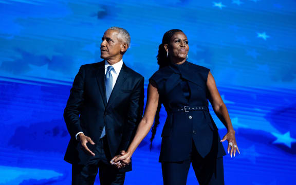 Former President Barack Obama and former first lady Michelle Obama appear on stage on the second night of the Democratic National Convention at the United Center in Chicago on August 20, 2024.