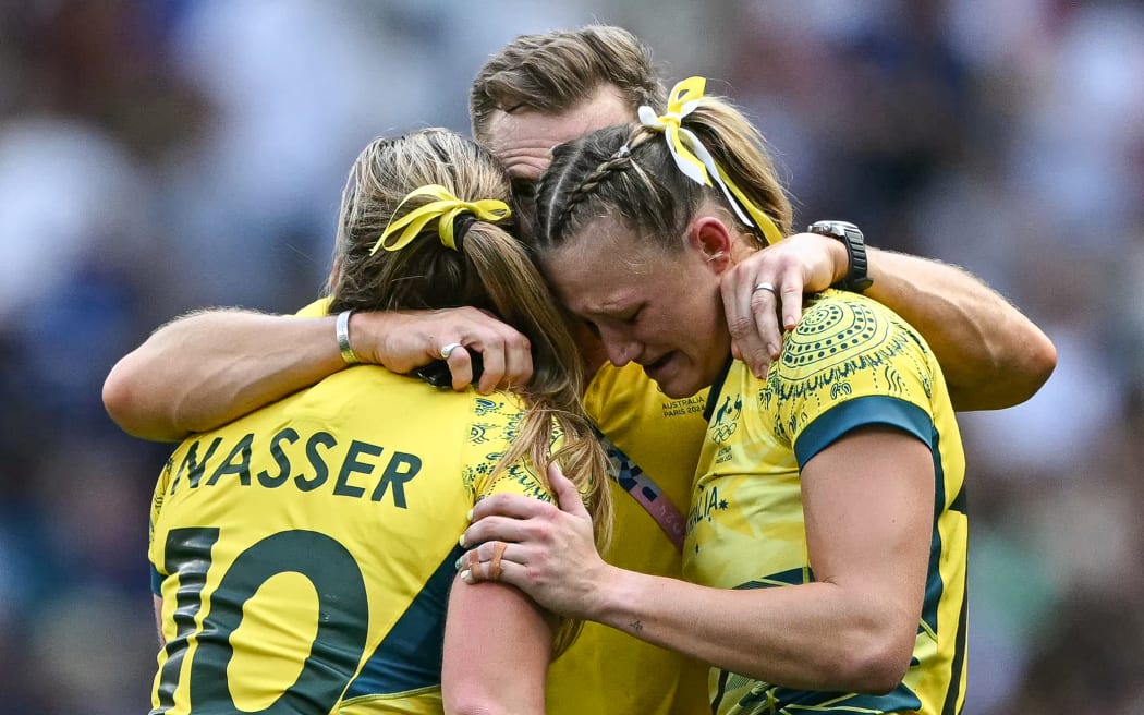 Australia's Maddison Levi (R) and Australia's Isabella Nasser (L) react after the women's semi-final rugby sevens match between Canada and Australia during the Paris 2024 Olympic Games at the Stade de France in Saint-Denis on July 30, 2024. (Photo by CARL DE SOUZA / AFP)