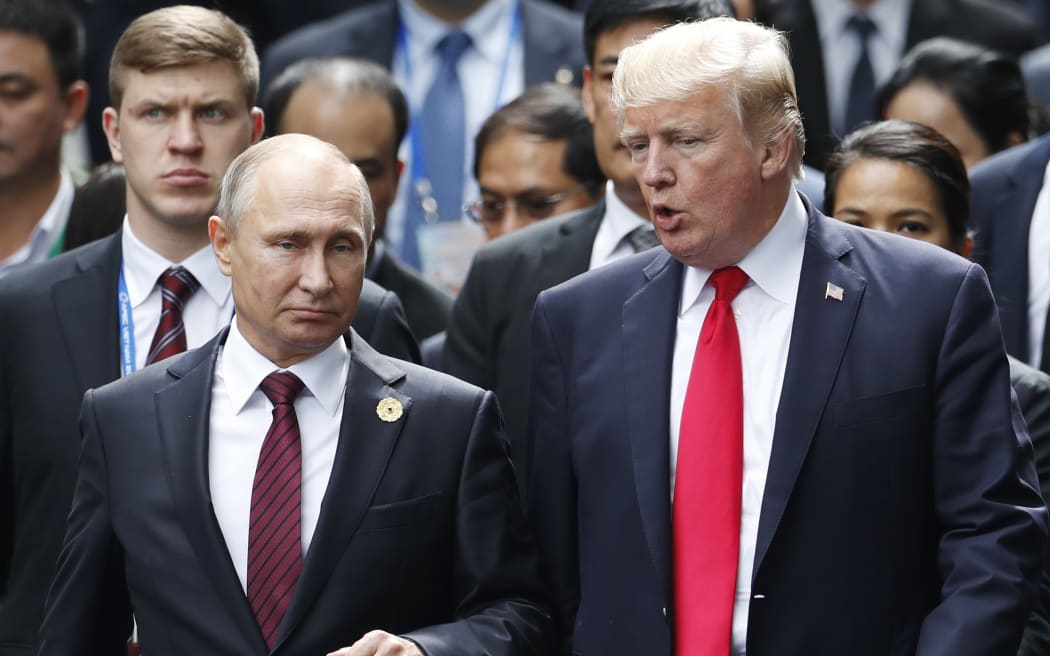 (FILES) November 11, 2017 US President Donald Trump and Russian President Vladimir Putin make their way to  the "family photo" during the APEC leaders' summit in Danang, Vietnam.