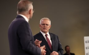 Australian Prime Minister Scott Morrison (right) and leader of the opposition, Anthony Albanese, participate in the first leaders' debate of the 2022 federal election campaign at the Gabba in Brisbane on April 20, 2022.