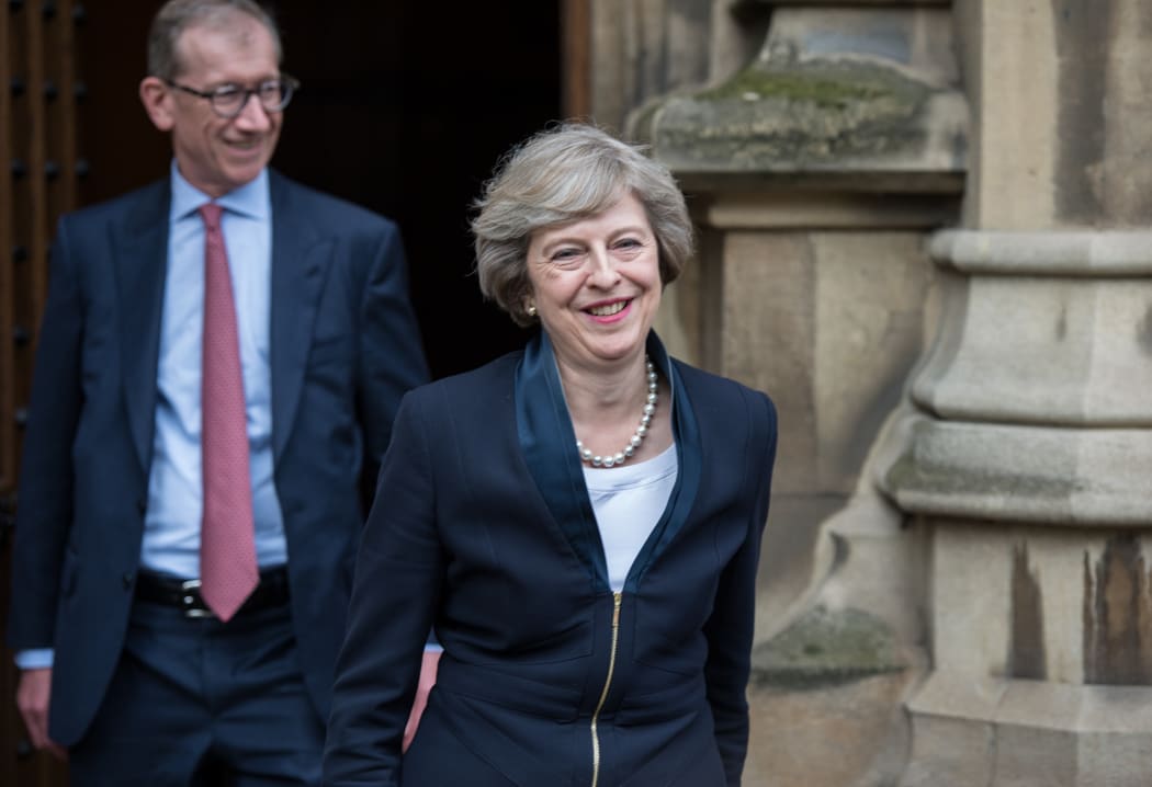 Theresa May with husband Philip prepares to speak to media.
