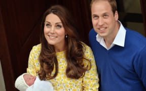 The new parents look up to waiting cameras outside the hospital.