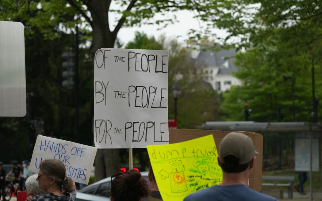 Protesters gather outside the Vice President's residence to protest Trump, Vance, and DOGE in the United States on April 19, 2025. The protest is part of the 50501 protest movement across the United States. (Photo by Andrew Leyden/NurPhoto) (Photo by Andrew Leyden / NurPhoto / NurPhoto via AFP)