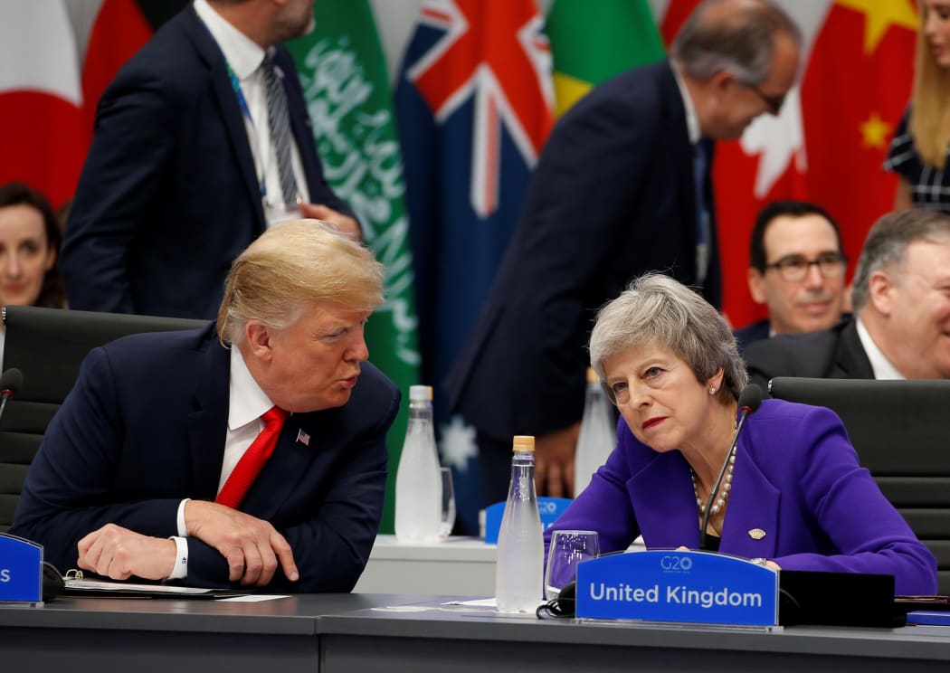 U.S. President Donald Trump (L) chats with British Prime Minister Theresa May (R) during a special session entitled 'Fair And Sustainable Future' as part of G20 Leaders Summit in Buenos Aires, Argentina on November 30, 2018.