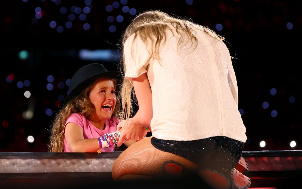 A young fan reacts after receiving the "22 hat" - given to one lucky fan at each show - from Taylor Swift at the MCG 16 February 2024. (Photo by Graham Denholm/TAS24/Getty Images for TAS Rights Management)