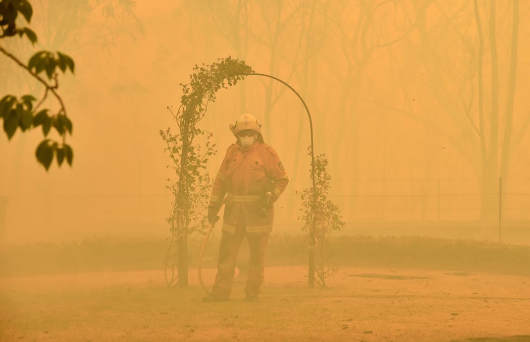 A fireman fights a bushfire to protect a property in Balmoral, 150 kilometres southwest of Sydney on December 19.