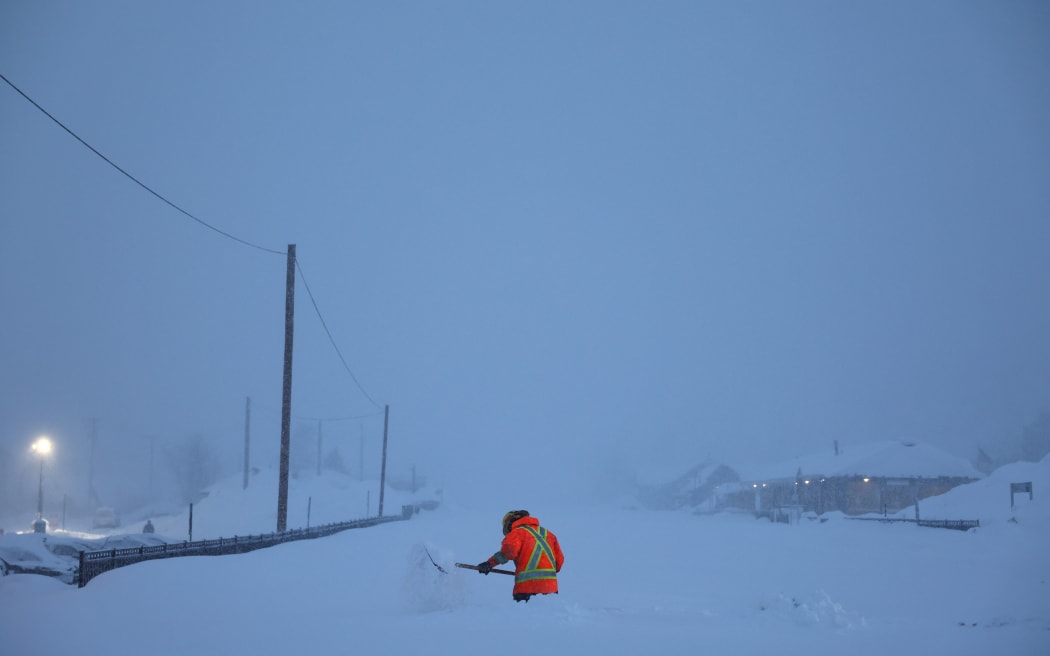 TRUCKEE, CALIFORNIA - MARCH 02: A Union Pacific worker shovels snow near the railroad tracks during a powerful multiple day winter storm in the Sierra Nevada mountains on March 02, 2024 in Truckee, California. Blizzard warnings were issued with snowfall of up to 12 feet and wind gusts over 100 mph expected in some higher elevation locations. Yosemite National Park is closed and a 50-mile stretch of Interstate 80 was shut down yesterday due to the storm.   Mario Tama/Getty Images/AFP (Photo by MARIO TAMA / GETTY IMAGES NORTH AMERICA / Getty Images via AFP)