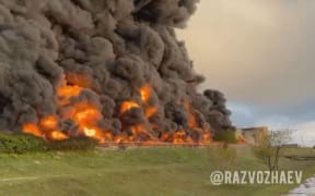 A video grab taken from footage released on 29 April, 2023, on the Telegram channel of Mikhail Razvozhayev, the Moscow-installed governor of Sevastopol, shows a huge fire at a fuel depot in Sevastopol, the main port in Moscow-annexed Crimea, with authorities saying it was the result of a drone attack.