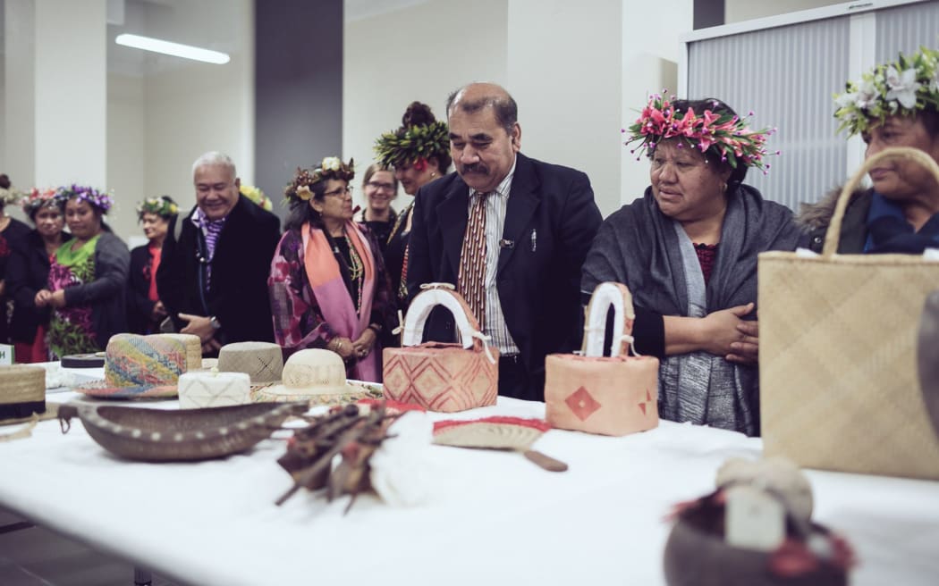 Members of the Cook Islands community look at Auckland Museum's extensive collection, which is being brought out as part of a new project.
