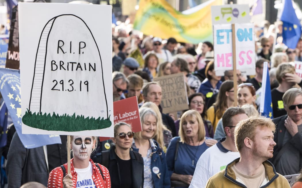 A woman holds a sign referring to the Brexit deadline of march 2019 during the People's Vote March for the Future in London.