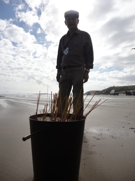 Burning joss sticks, Ching Ming in the Hokianga 2013.
