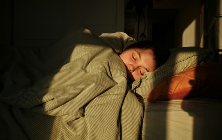 Person sleeping under a duvet.